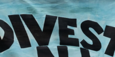 Flag saying Divest NJ with text FOSSIL FREE and PENSION FUNDS